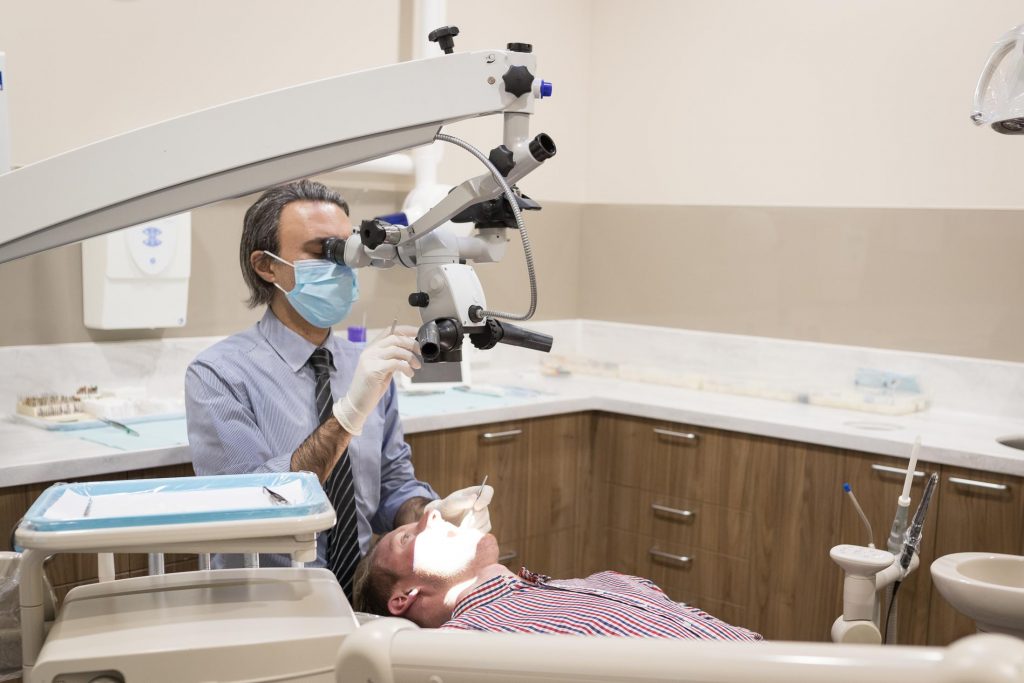 dentist performing Root canal treatment