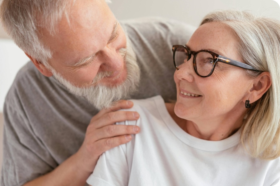 Couple smiling at each other after dentures.
