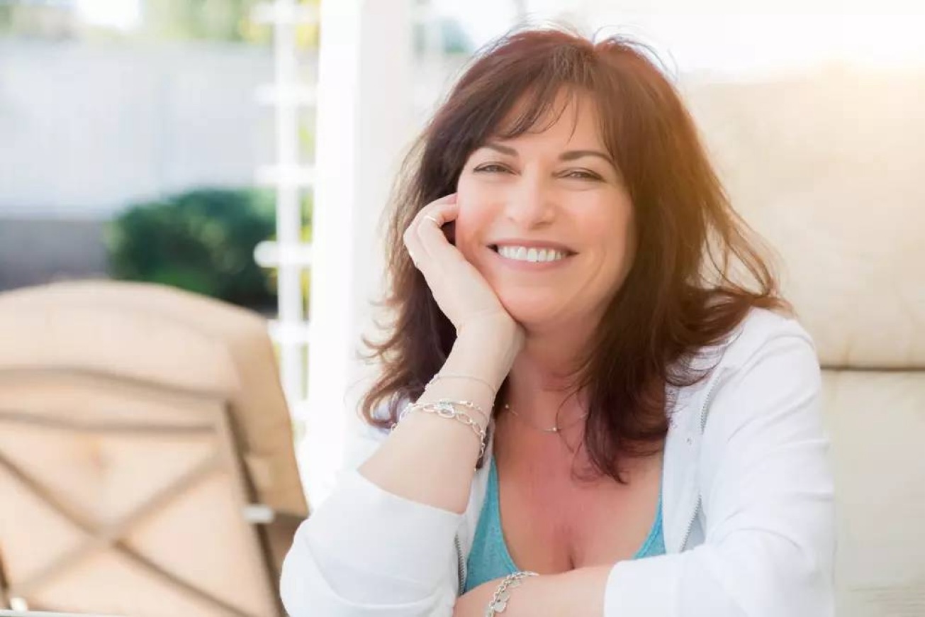 Women smiling confidently after smile design